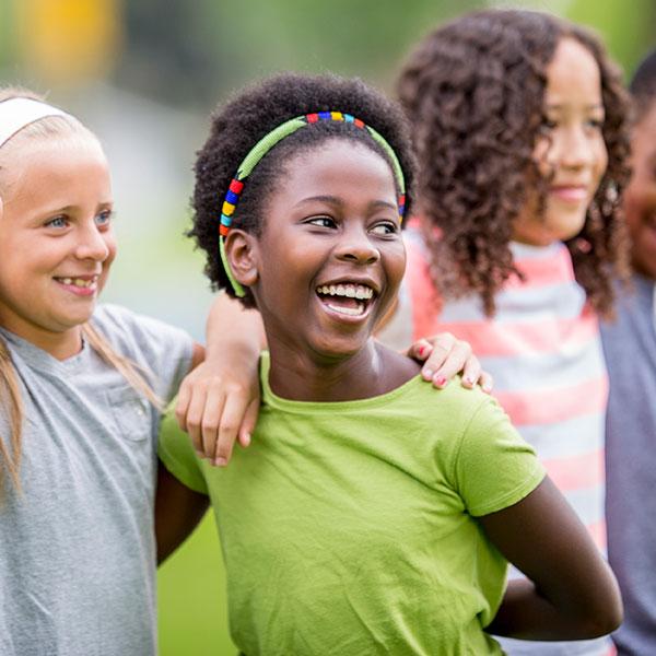 Young friends having fun outdoors and smiling