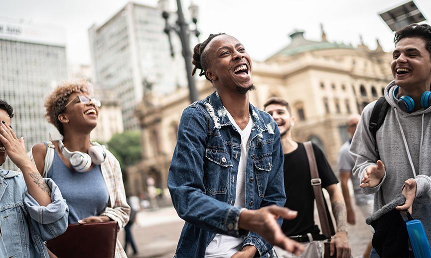 Un groupe d’amis parlant et dansant dans la rue.